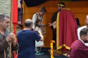 Il re consegna un oggetto a una bambina sul Cammino di Santiago