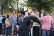 Il re consegna un oggetto cerimoniale a un bambino in piazza